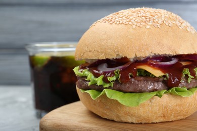 Delicious cheeseburger on table, closeup. Space for text