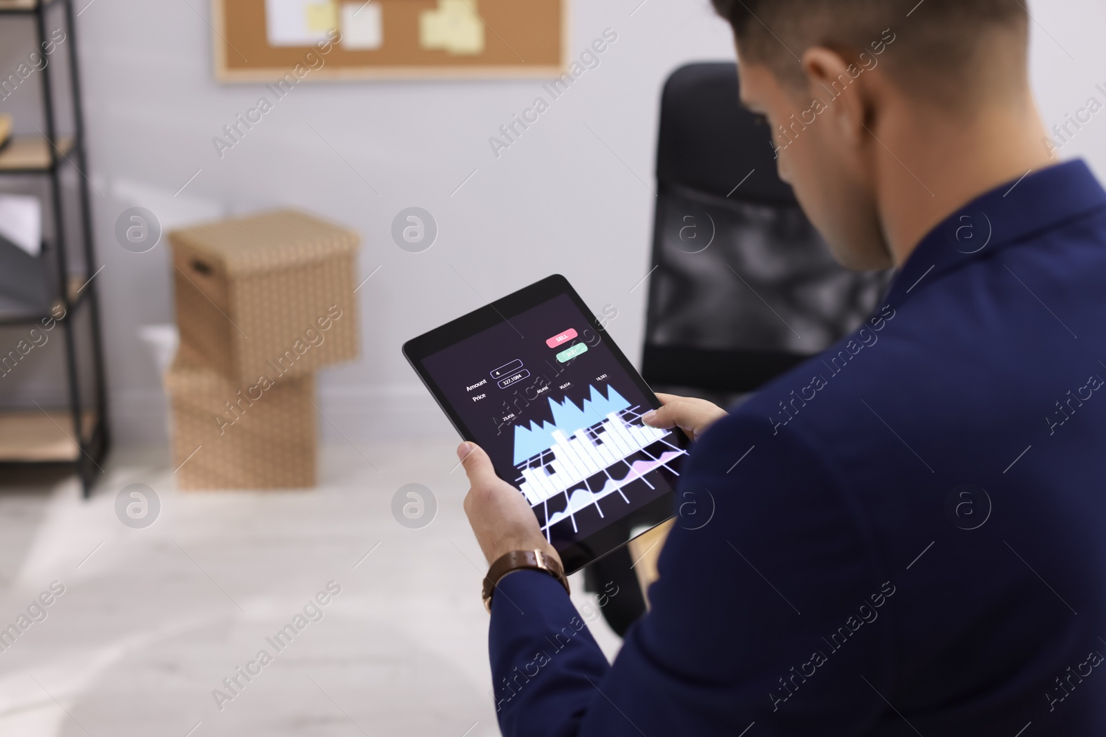 Photo of Businessman working with tablet in office, closeup. Forex trading