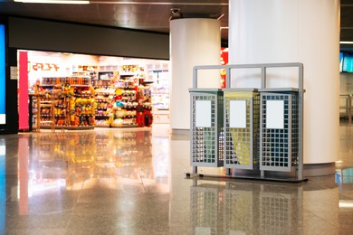 Photo of Sorting bins for waste recycling in shopping mall