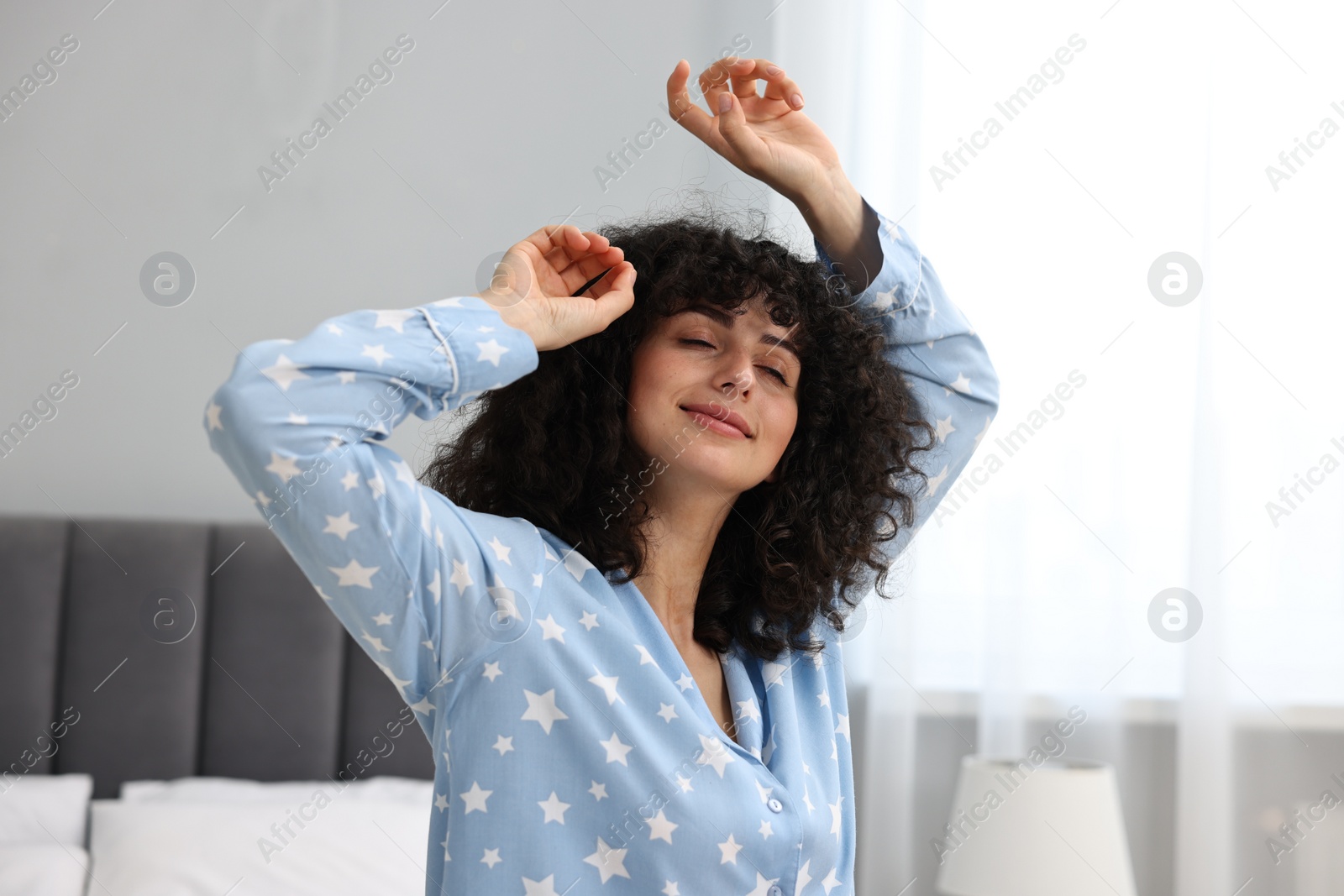 Photo of Beautiful young woman in stylish pyjama at home