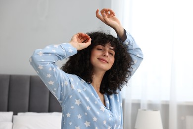 Beautiful young woman in stylish pyjama at home