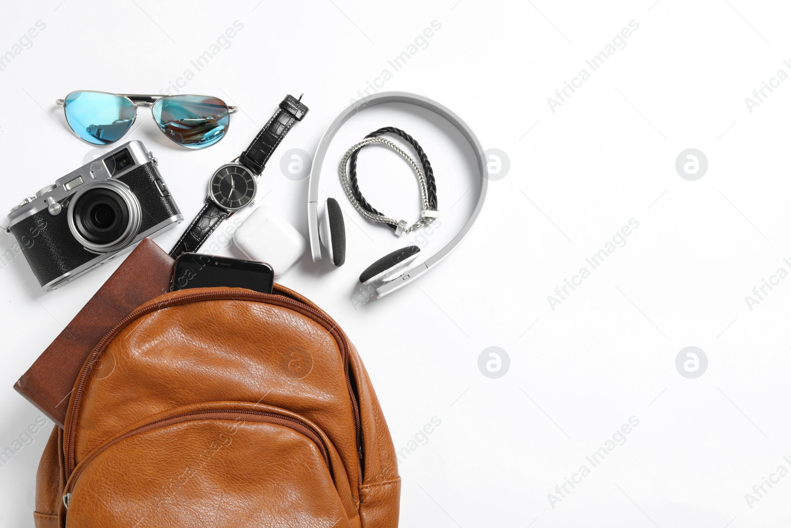 Photo of Stylish urban backpack with different items on white background, flat lay