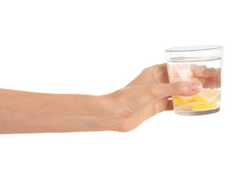 Photo of Young woman with glass of lemon water on white background, closeup