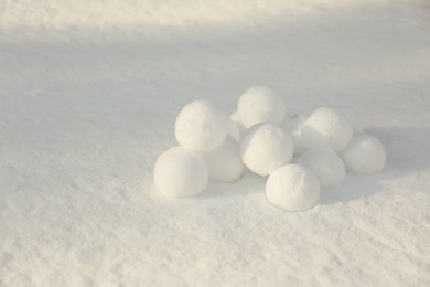 Pile of perfect round snowballs on snow outdoors
