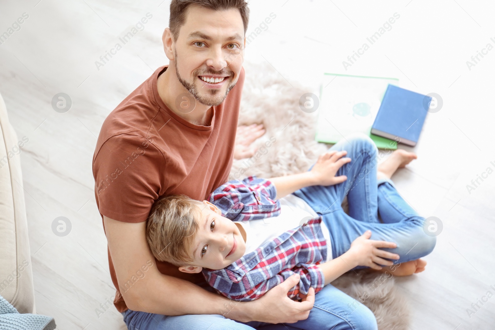 Photo of Little boy and his dad spending time together at home