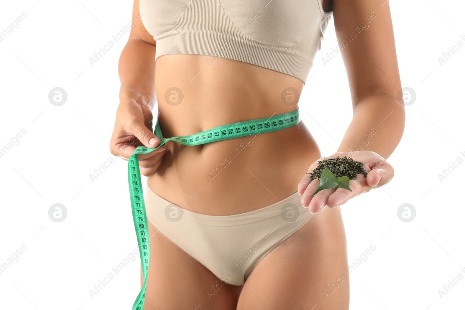 Photo of Young woman with measuring tape holding fresh and dry tea leaves on white background, closeup