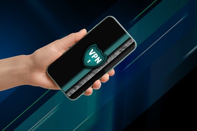 Image of Woman holding smartphone with switched on VPN on color background, closeup