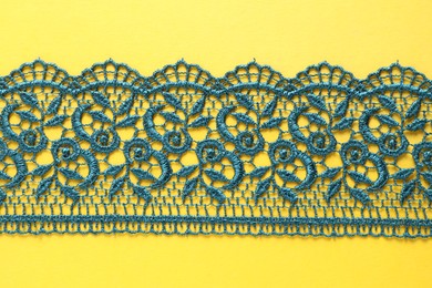 Green lace on yellow background, top view