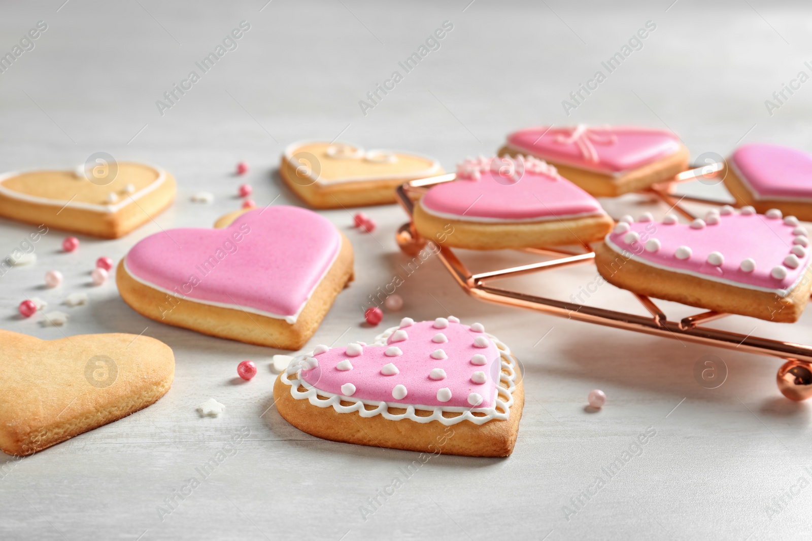 Photo of Composition with decorated heart shaped cookies on table