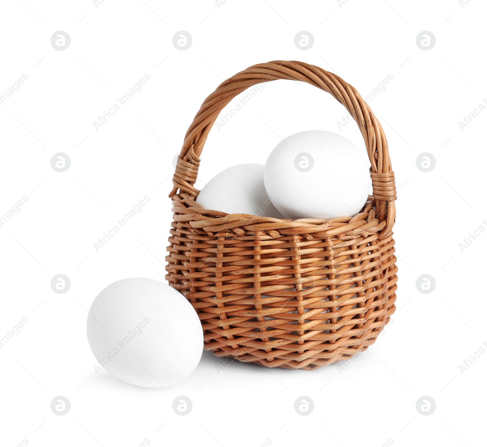 Photo of Chicken eggs in small wicker basket isolated on white