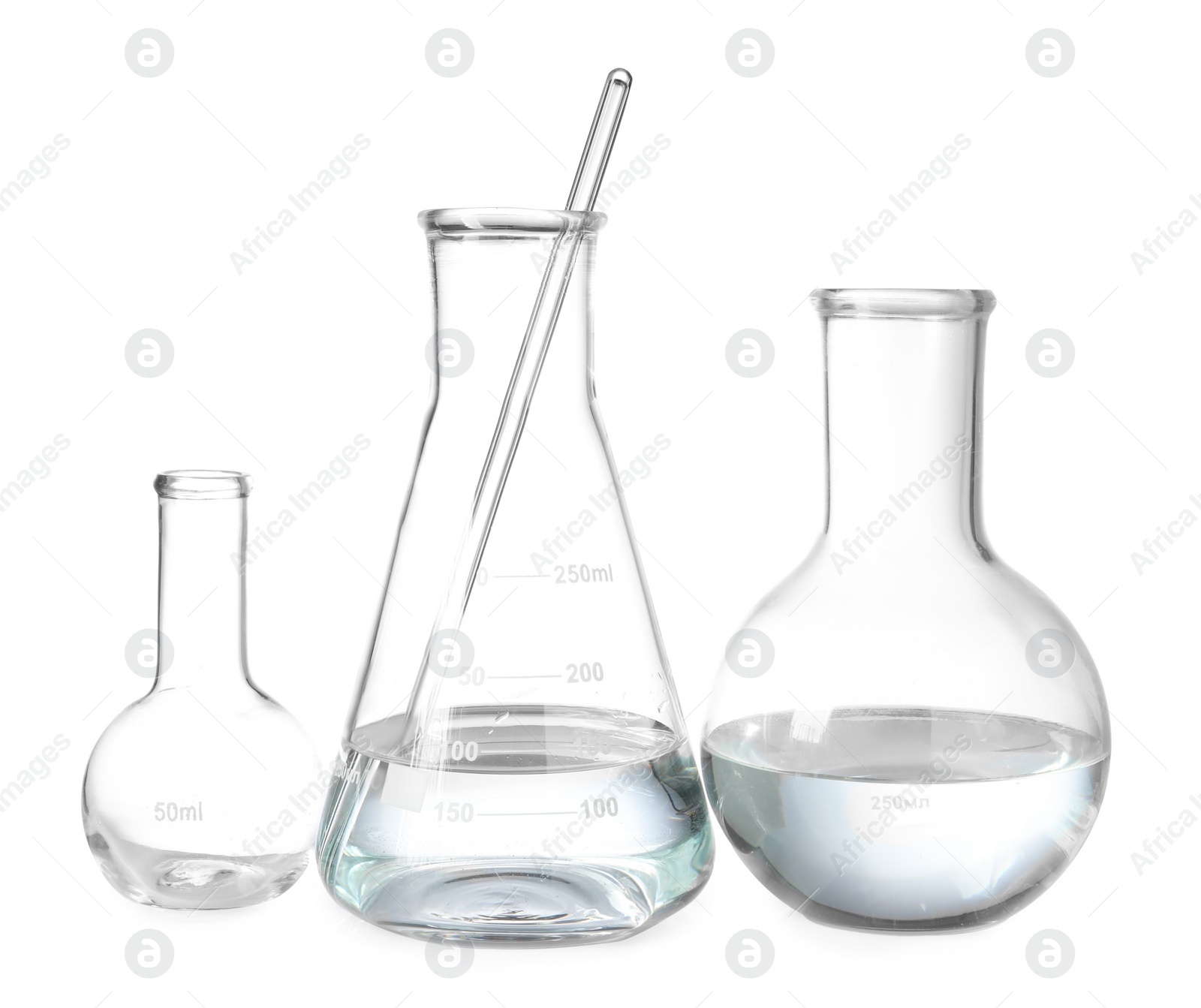 Photo of Glass flasks with water and stirring rod isolated on white