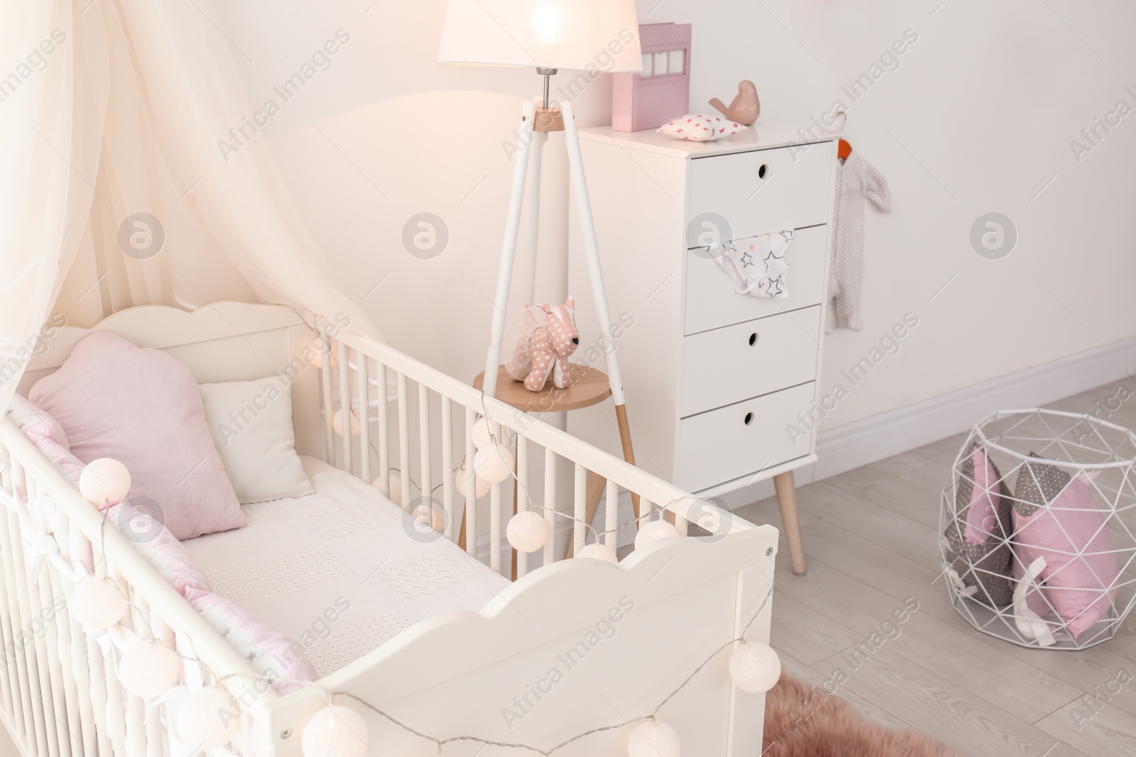 Photo of Interior of baby room with comfortable crib