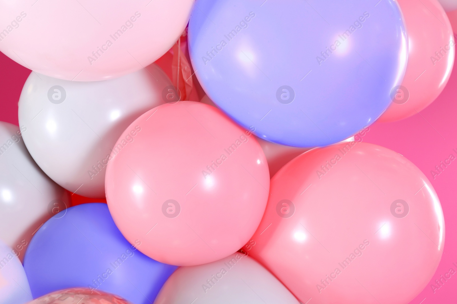 Image of Beautiful colorful balloons on pink background, closeup. Party decor 