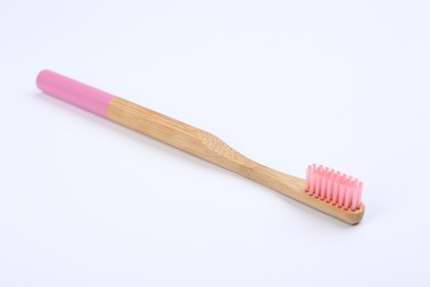Photo of Bamboo toothbrush with pink bristle isolated on white