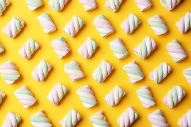 Photo of Delicious colorful marshmallows on yellow background, flat lay