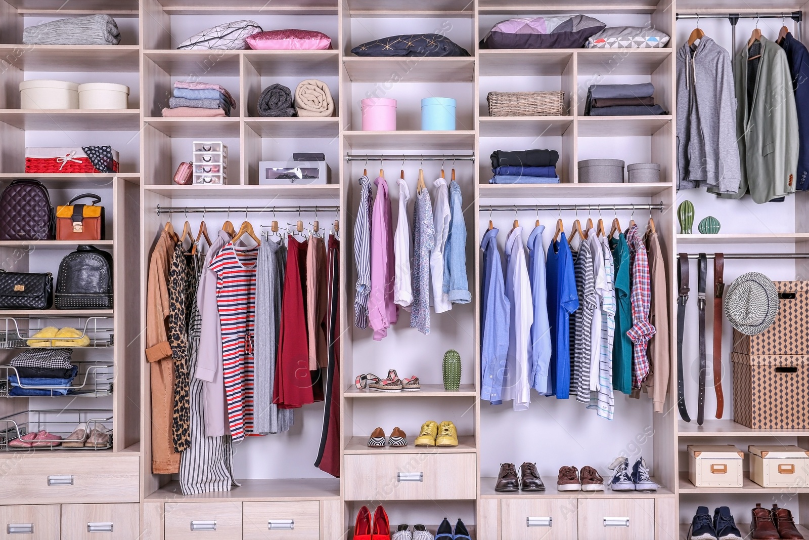 Photo of Large wardrobe with different clothes, home stuff and shoes