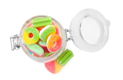 Photo of Glass jar of tasty colorful jelly candies on white background, top view