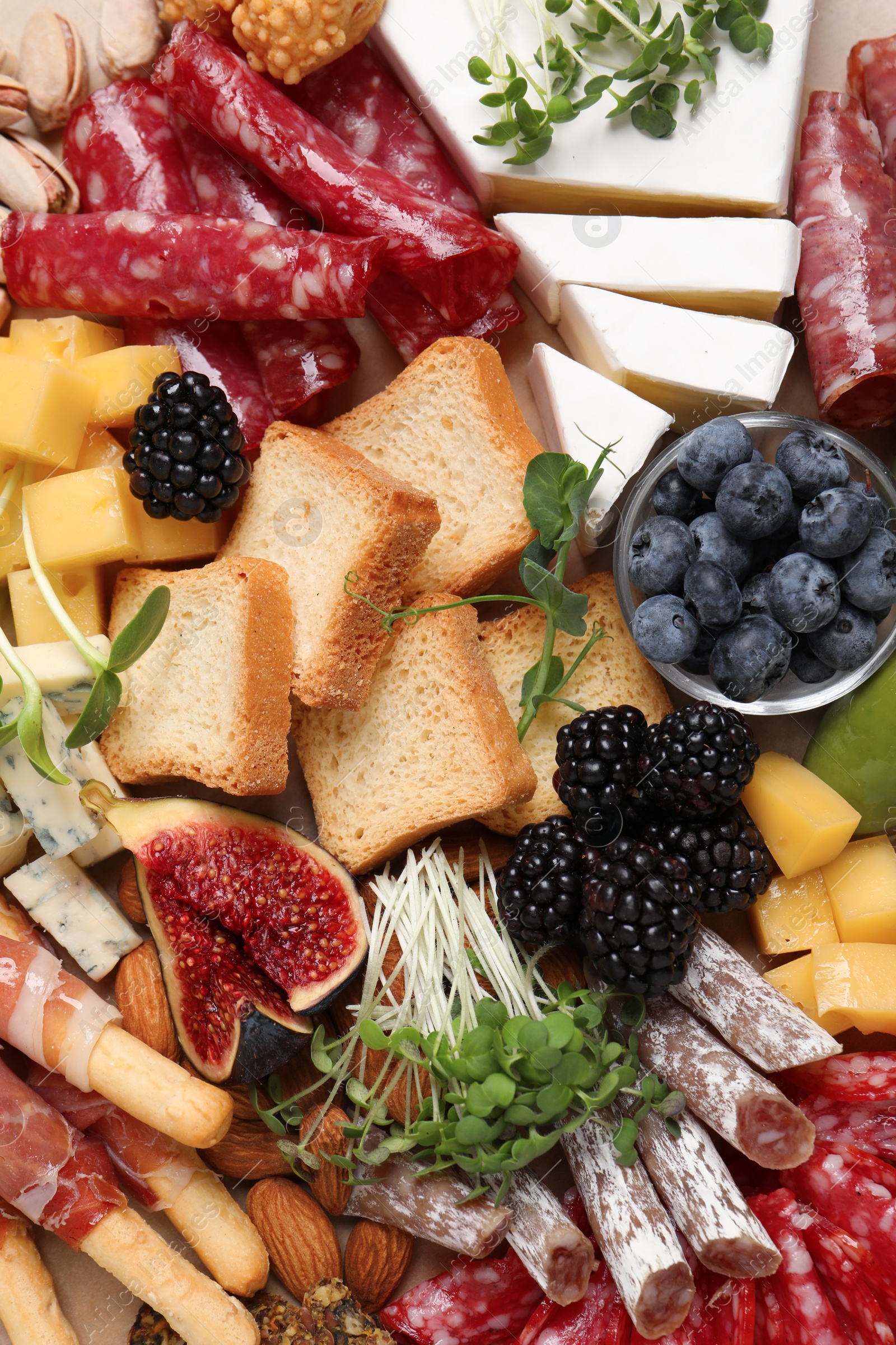 Photo of Different tasty appetizers as background, top view