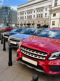 Photo of Different modern cars parked on city street