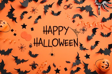Image of Frame made with Halloween decor elements on orange background, flat lay