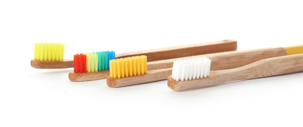 Photo of Bamboo toothbrushes on white background. Dental care