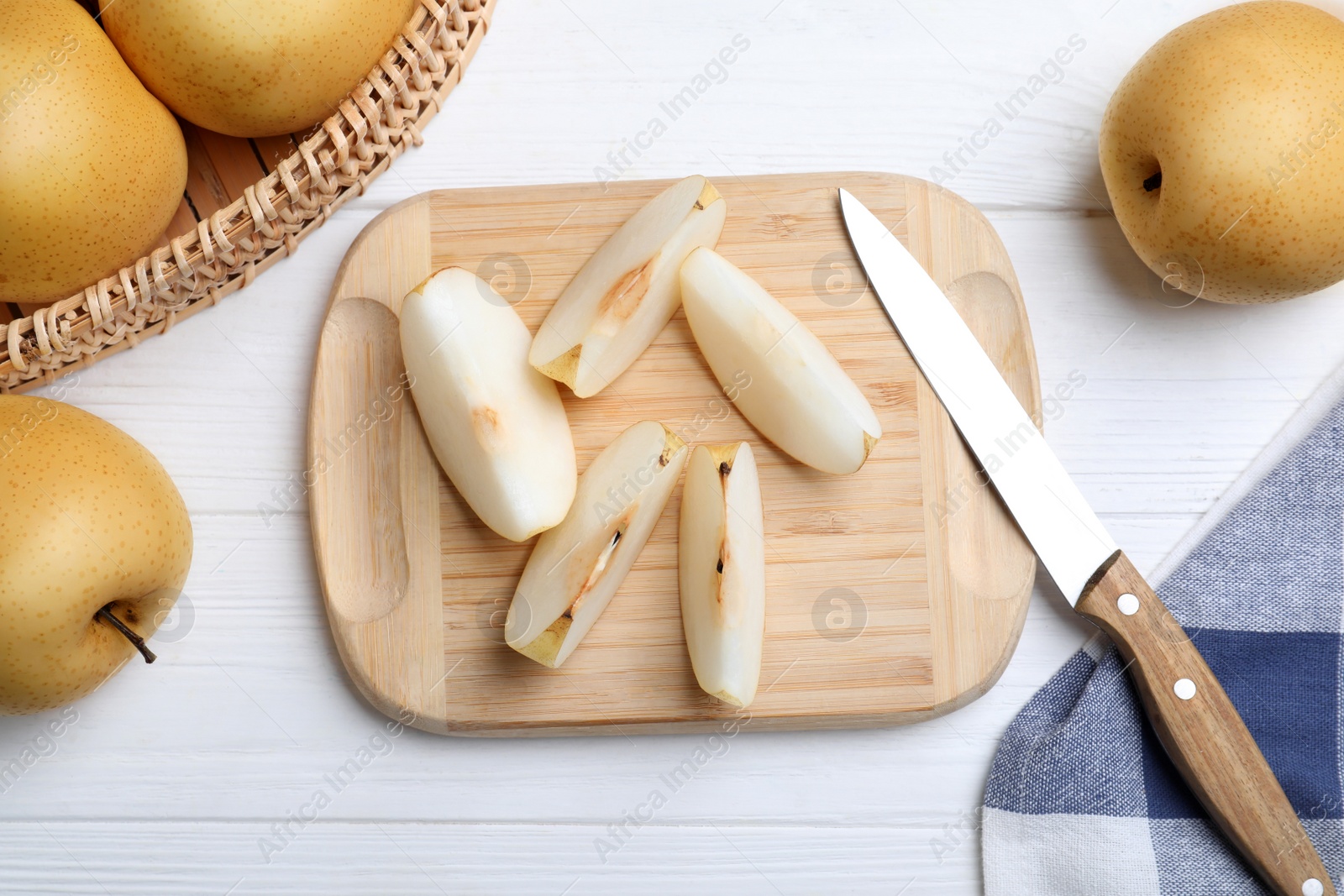 Photo of Cut and whole apple pears on white wooden table, flat lay