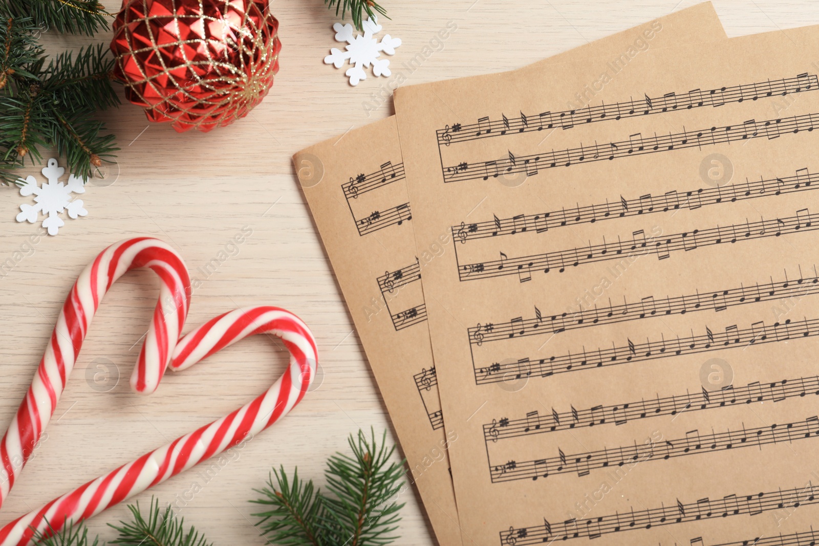 Photo of Flat lay composition with Christmas music sheets on wooden background