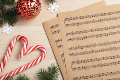 Photo of Flat lay composition with Christmas music sheets on wooden background