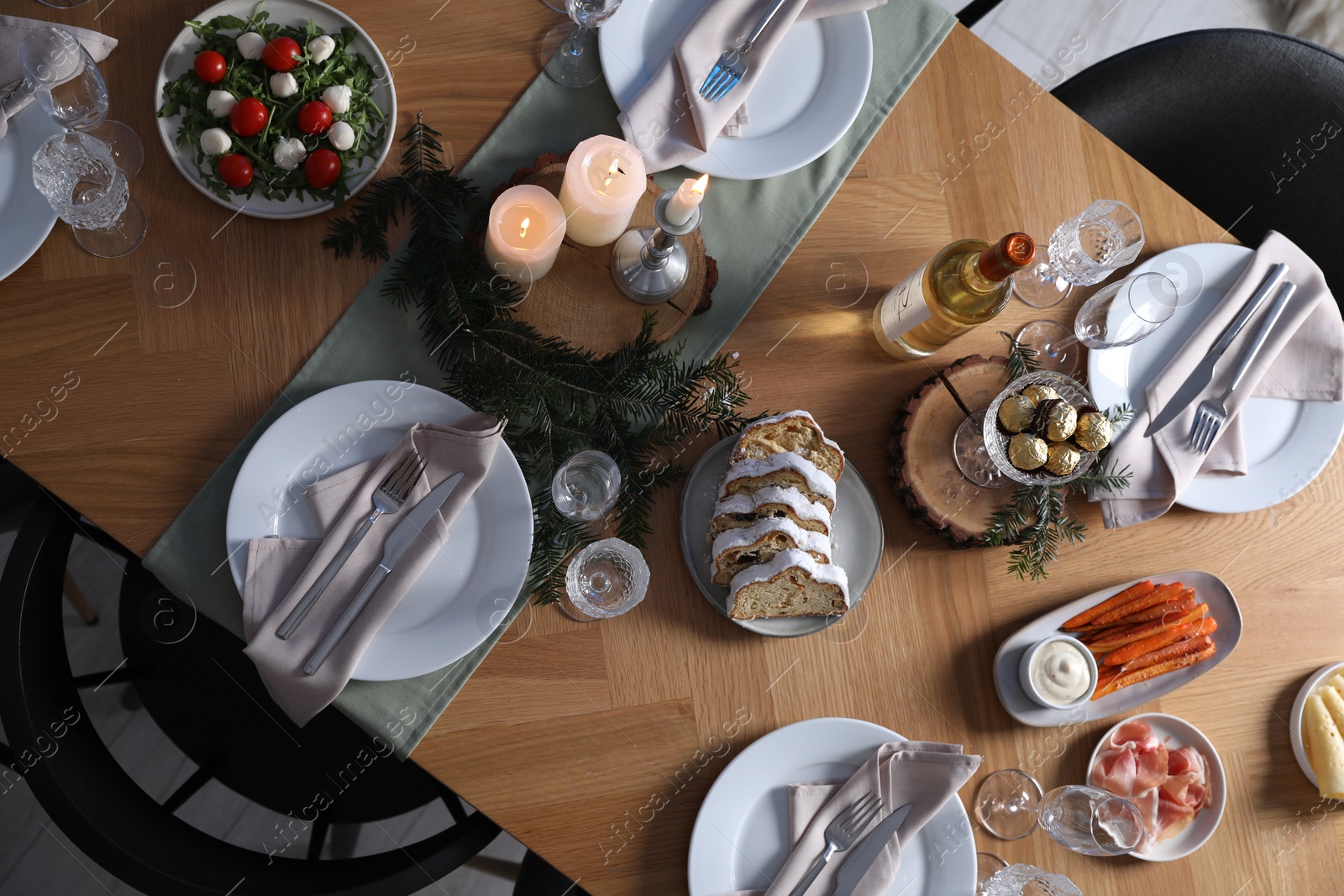 Photo of Christmas table setting with festive decor and dishware, top view