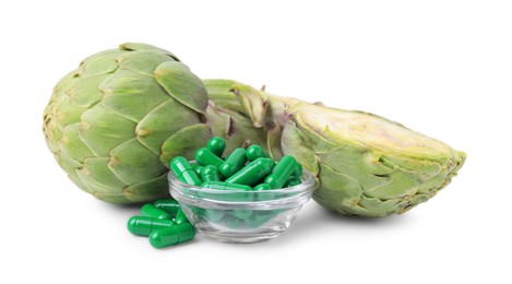 Photo of Fresh artichokes and pills isolated on white