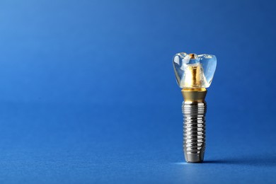 Photo of Educational model of dental implant on blue background. Space for text