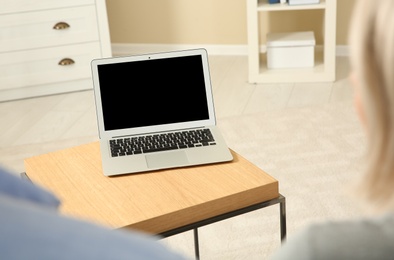 Couple using video chat on laptop at home, closeup. Space for text