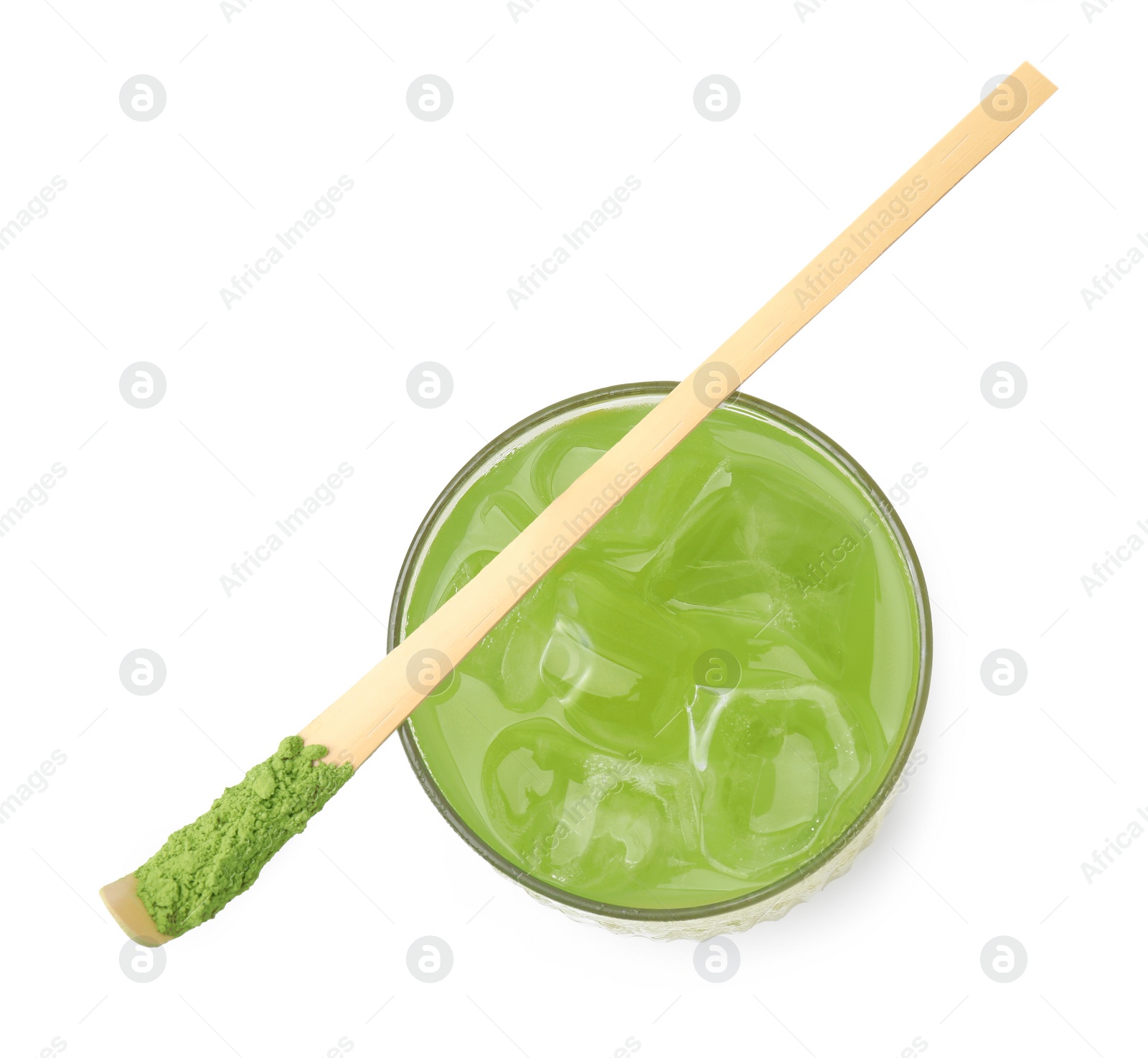 Photo of Glass of delicious iced green matcha tea and bamboo spoon with powder isolated on white, top view