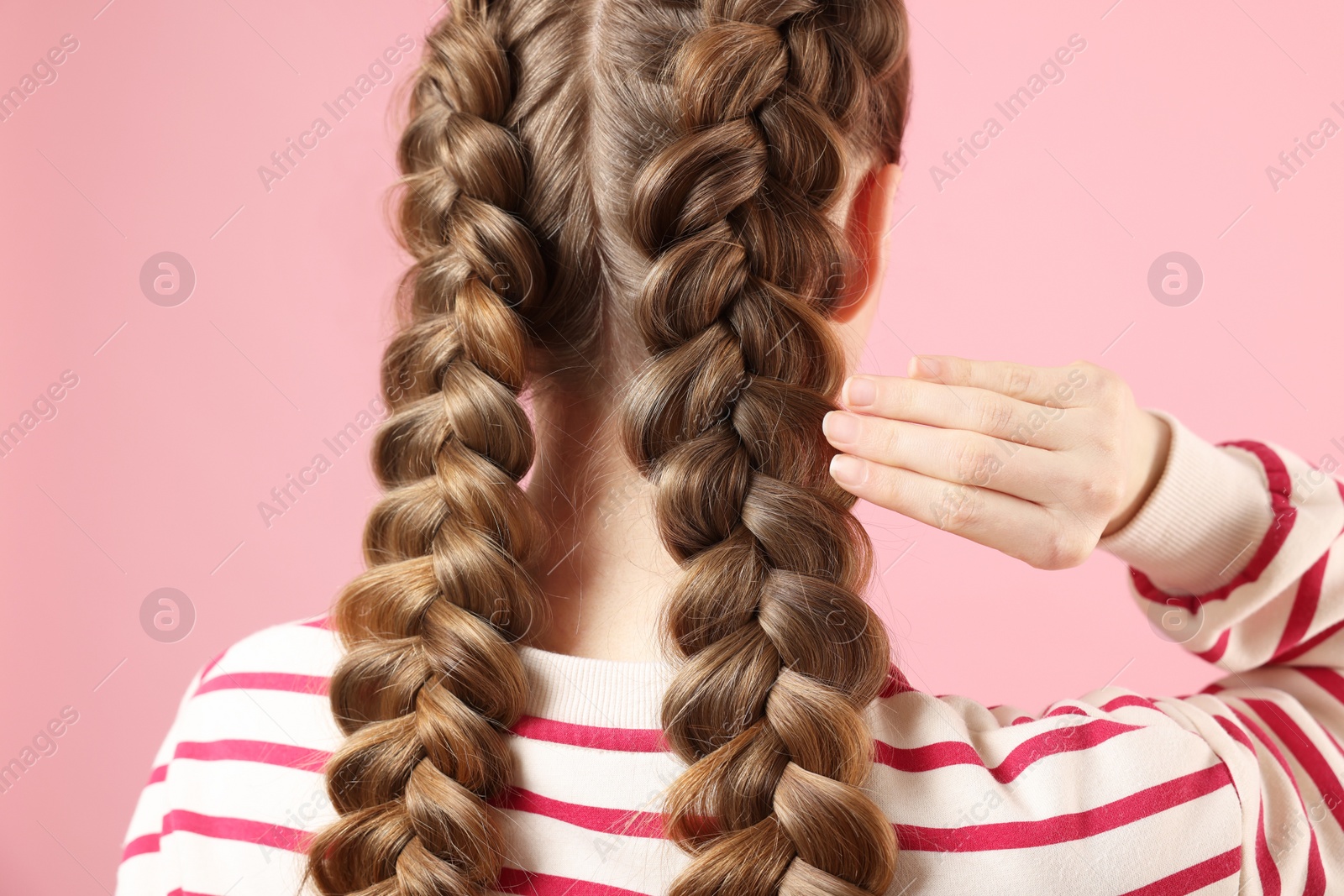 Photo of Woman with braided hair on pink background, back view