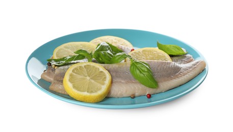 Photo of Blue plate with delicious salted herring fillets, basil, lemon slices and peppercorns isolated on white