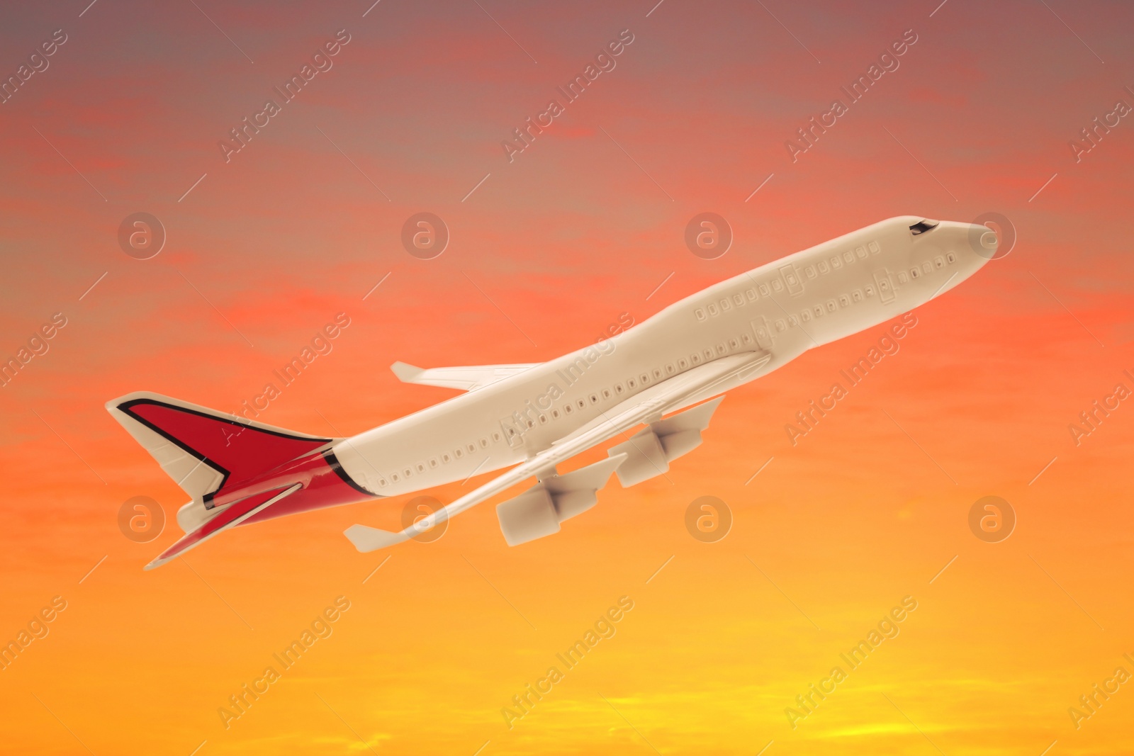 Image of View of airplane in beautiful sky at sunset. Travel concept