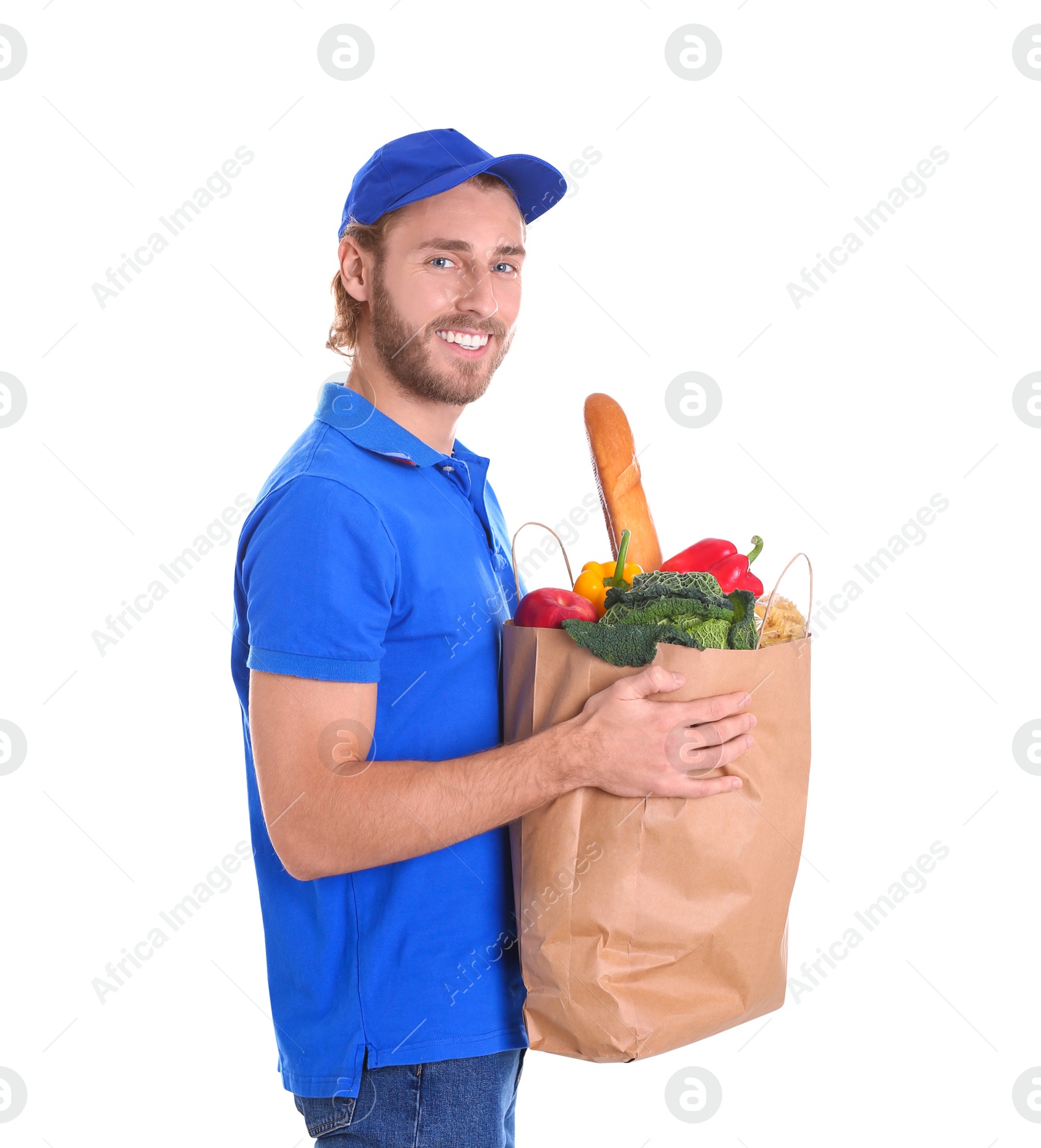 Photo of Delivery man holding paper bag with food products on white background