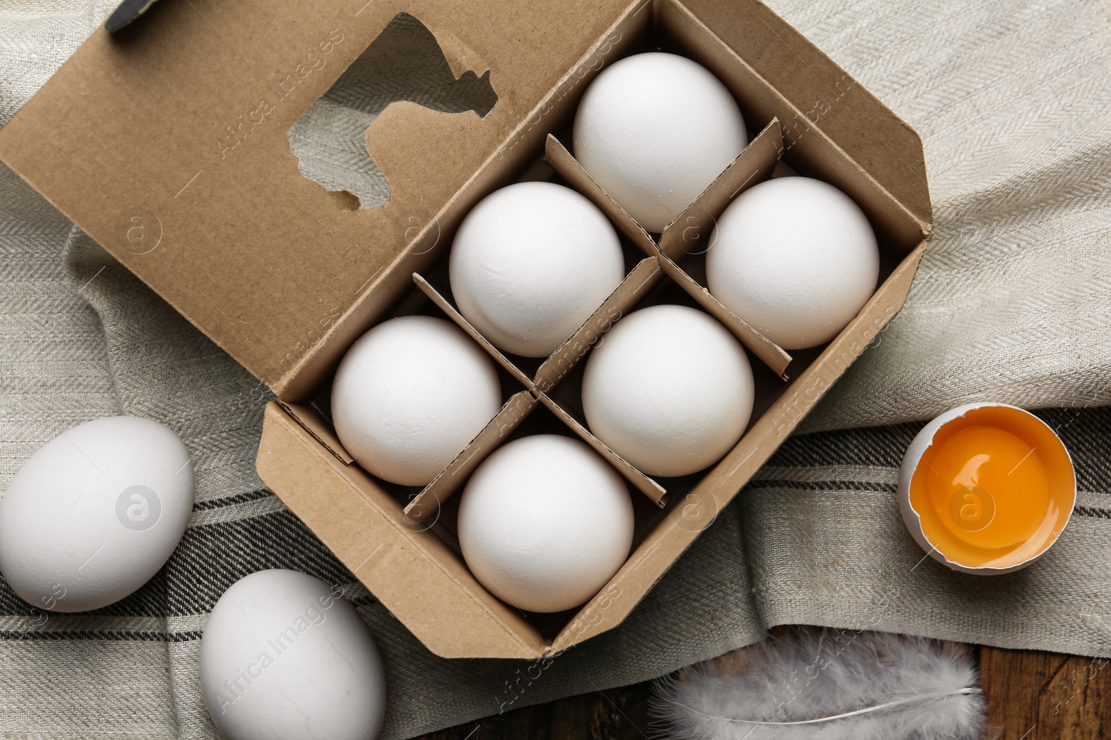 Photo of Fresh raw chicken eggs in box on table, flat lay