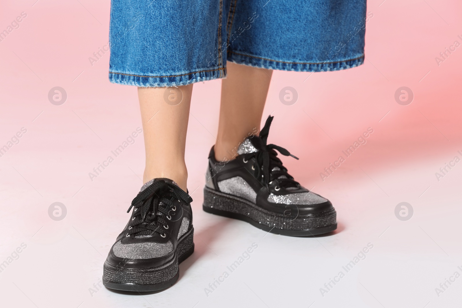 Photo of Woman in stylish shoes on color background, closeup