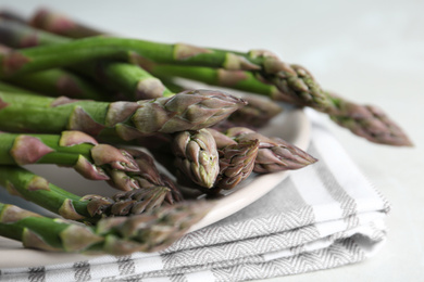 Photo of Fresh raw asparagus on table, closeup view
