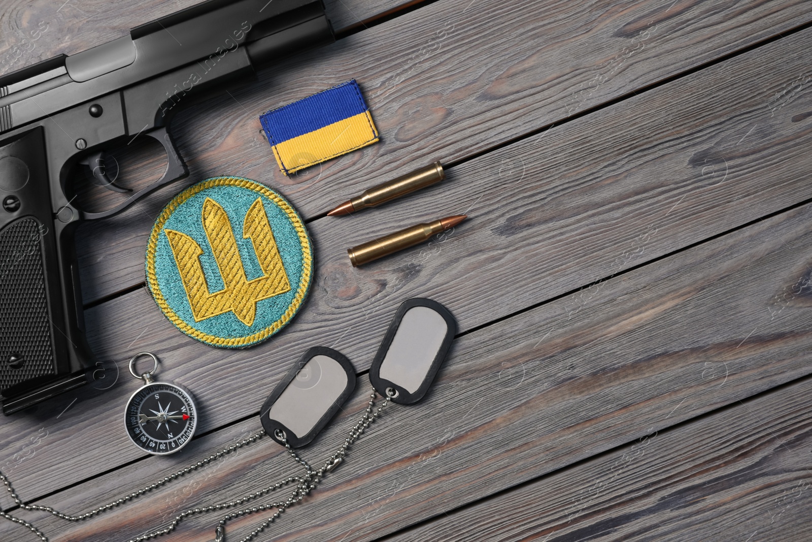 Photo of MYKOLAIV, UKRAINE - SEPTEMBER 19, 2020: Flat lay composition with Ukraine military equipment on grey wooden table, space for text