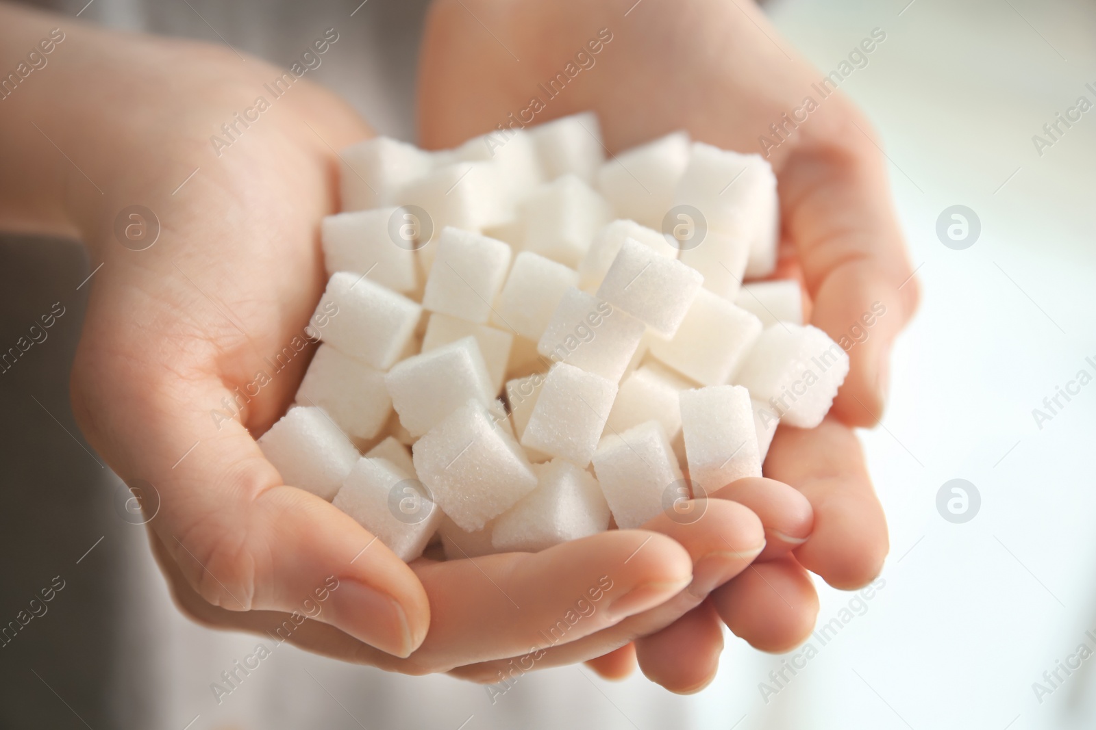 Photo of Woman holding sugar cubes, closeup