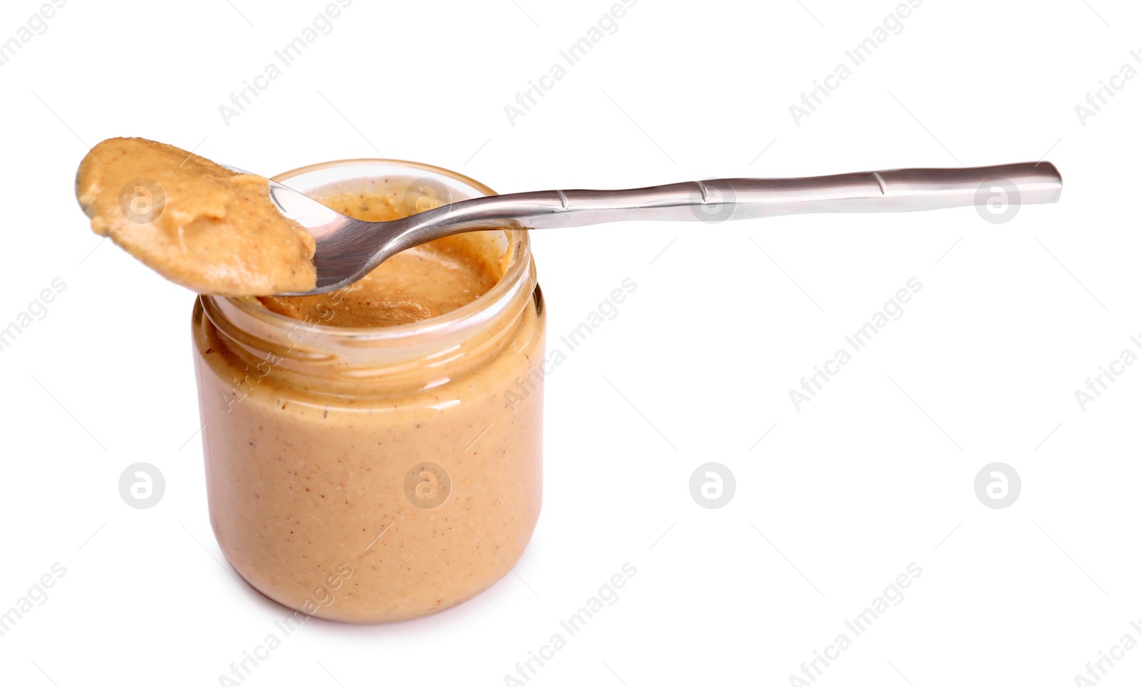 Photo of Tasty nut paste in jar and spoon isolated on white