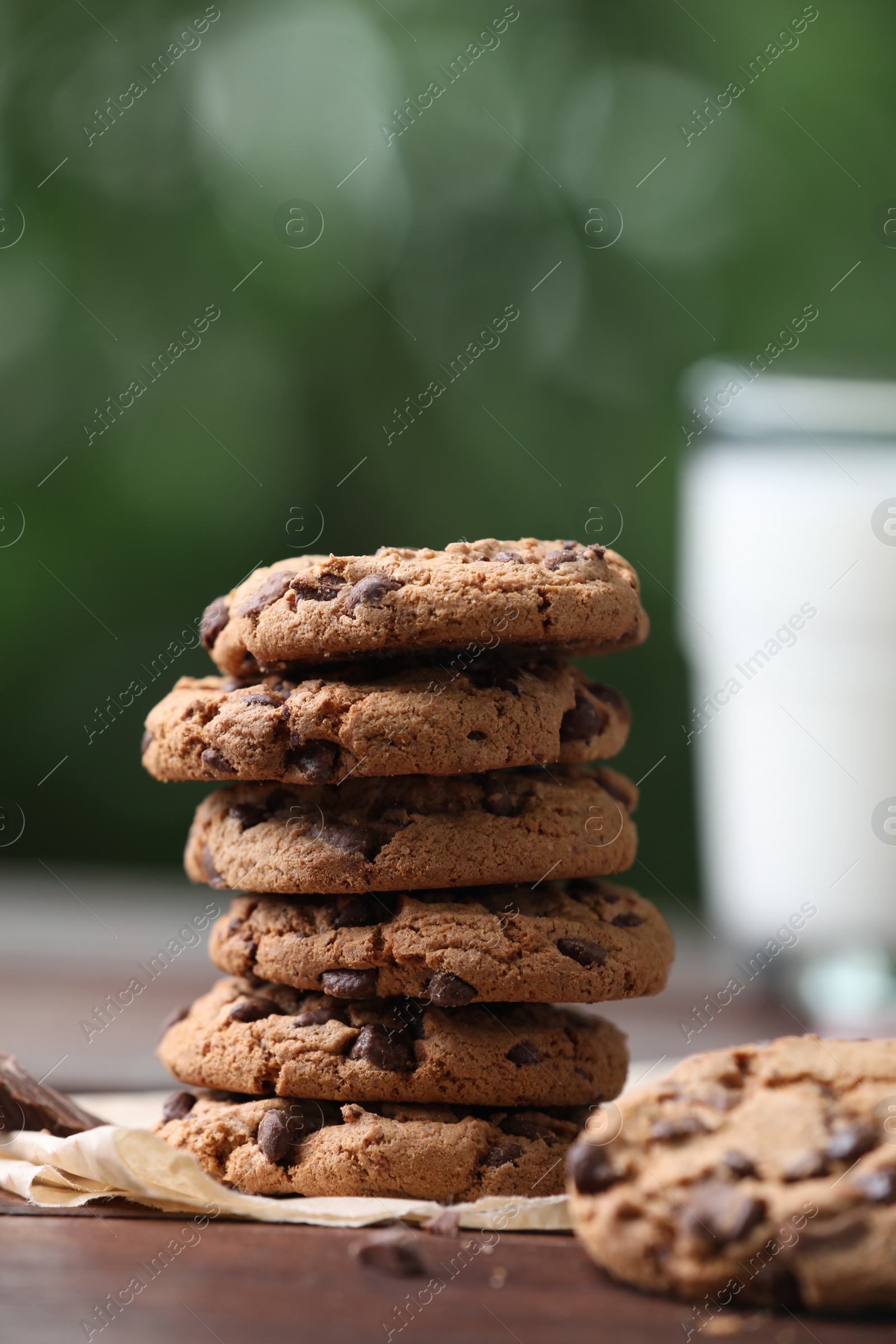 Photo of Delicious chocolate chip cookies on wooden table, closeup