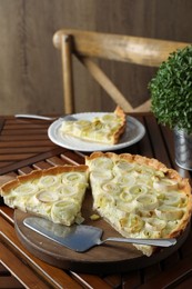 Tasty leek pie served on wooden table