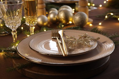 Photo of Table setting with festive lights and Christmas decor