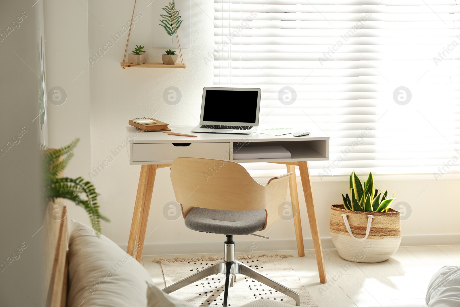 Photo of Stylish room interior with workplace near window