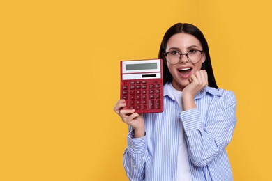 Photo of Emotional accountant with calculator on yellow background, space for text