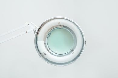 Photo of Medical lamp with magnifying glass in modern clinic