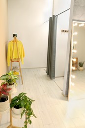 Photo of Dressing room in fashion store. Stylish design